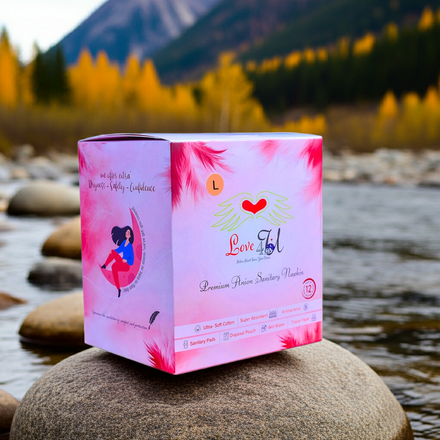 Pink box with 'Love & Lil' branding on a rock by a mountainous landscape