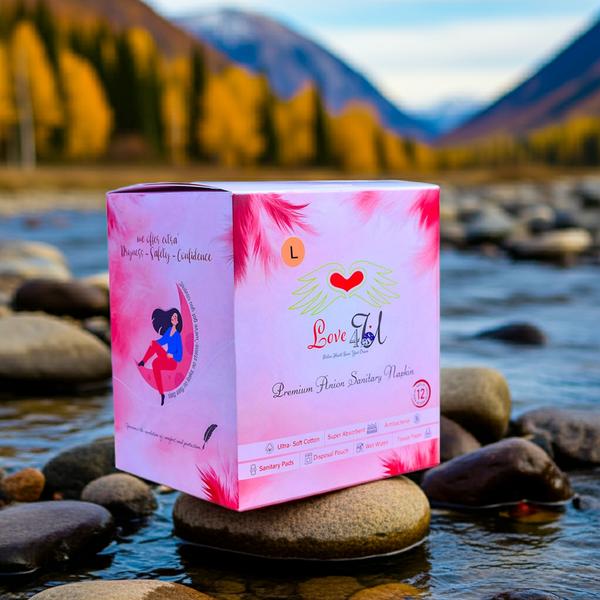 Pink box with 'Love & Tal' branding on a rock by a mountain lake